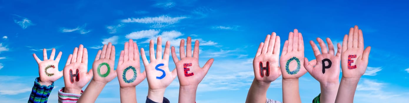 Children Hands Building Colorful English Word Choose Hope. Blue Sky As Background.
