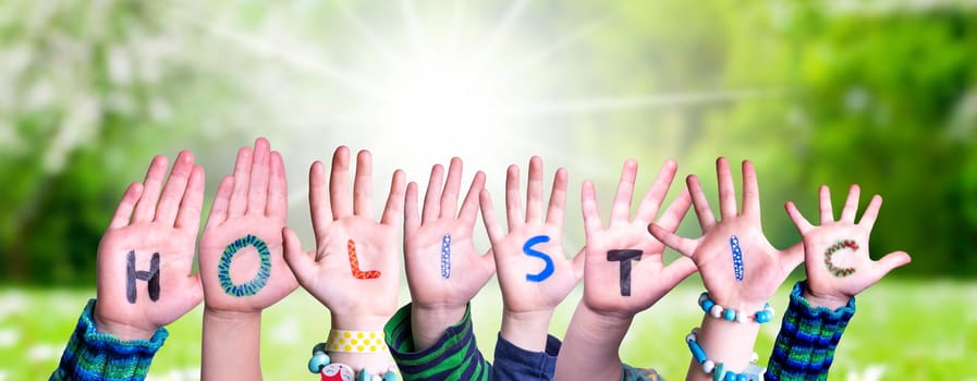 Children Hands Building Colorful English Word Holistic. Sunny Green Grass Meadow As Background.