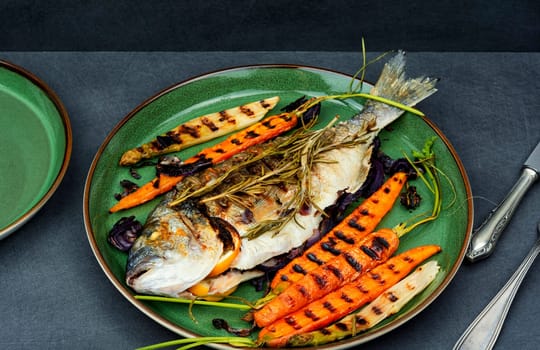 Barbecue whole dorado fish or sea bream with grilled vegetables. BBQ fish