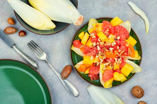 Delicious freshly salad of grapefruit, mango and chicory.