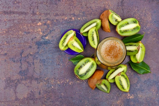 Delicious kiwi jam in a glass jar. Top view. Space for text