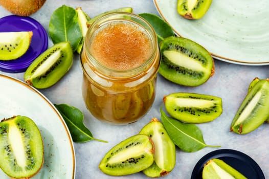 Delicious kiwi jam in a glass jar. Top view. Space for text