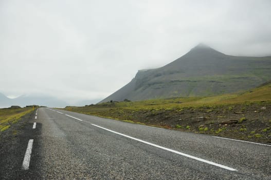 Coastal road in Iceland leading through mountains