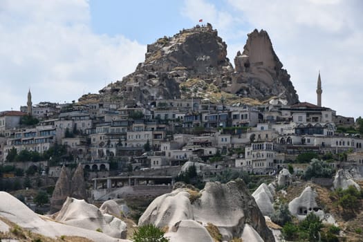 Houses on the mountainside and the Uchisar Castle in Uchisar, Cappadocia, Turkey