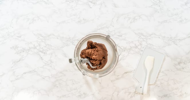 Top-down view of a glass bowl filled with combined cookie dough for Pale Gingerbread Cookies with Subtle Spice Flavor. The dough appears evenly mixed and pale in color, ready for wrapping and chilling.