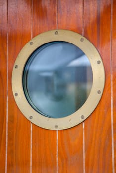 A porthole on a door on a ship.