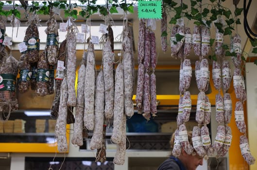 Cremona, Italy - September 7, 2022: Traditional meat products sold at a street stall during the farmers market in Cremona, Lombardy, Italy