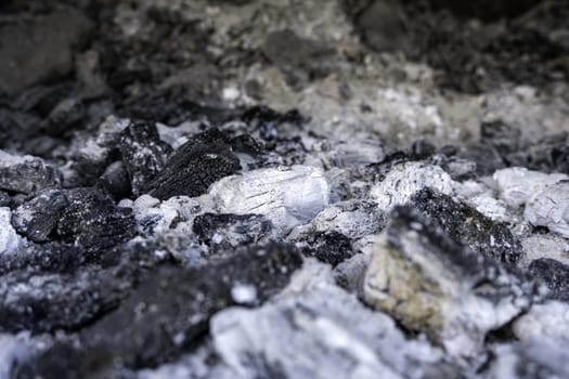 Detail of extinguished black carbon in a barbecue, burned wood