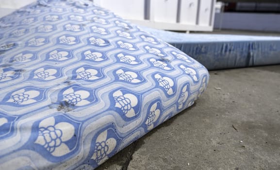 Detail of old dirty and damaged mattresses, recycling