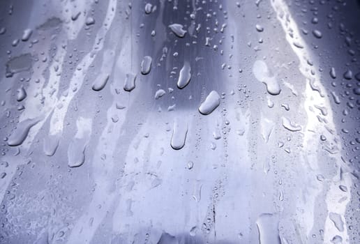 Detail of stainless steel surface wet from the rain
