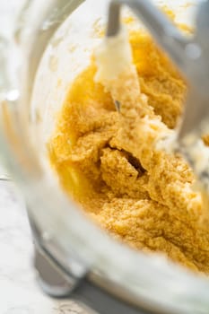 Creamed butter and sugar mixture, light and fluffy in texture, ready for dry ingredient addition.