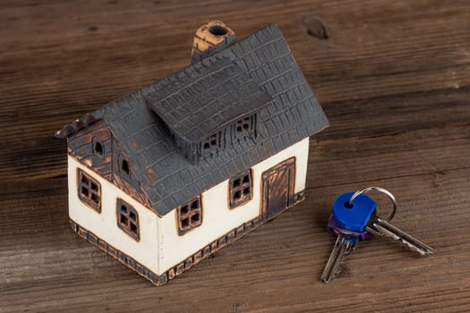 Model house and keys on table. Concept of dream house