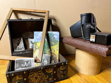 an old rare SLR camera in a frame and in a chest
