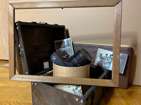 an old rare SLR camera in a frame and in a chest