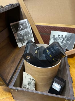 an old rare SLR camera in a frame and in a chest
