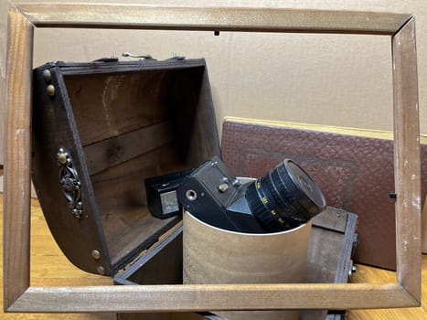 an old rare SLR camera in a frame and in a chest