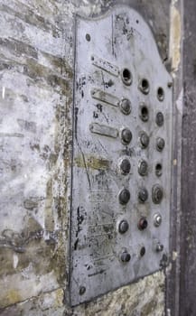 Detail of old entryphone in an abandoned house, ruin and dirt