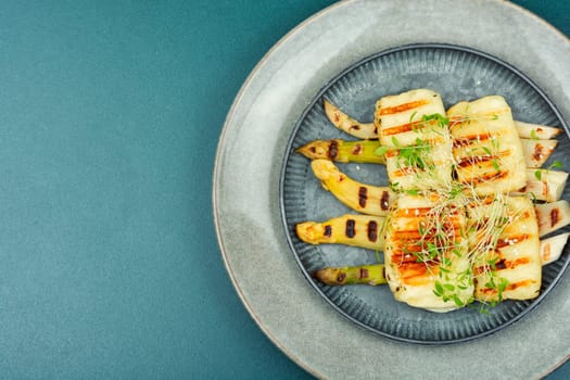 Warm salad with white asparagus and fried halloumi cheese. Healthy food, space for text
