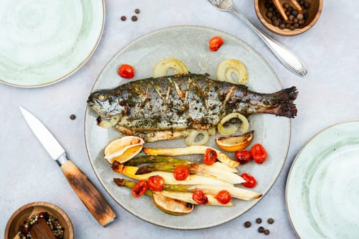 Delicious whole river trout baked with white asparagus and tomatoes.