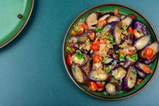 Spicy purple eggplant, tomato and garlic salad. Roast aubergine