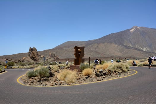 Teide National Park, Tenerife, Spain August 13, 2022 - Parking lot with sculpture at the Parador de Cañadas del Teide excursion restaurant and hotel at Roques de García in the national park overlooking Mount Teide on the Canary Island of Tenerife