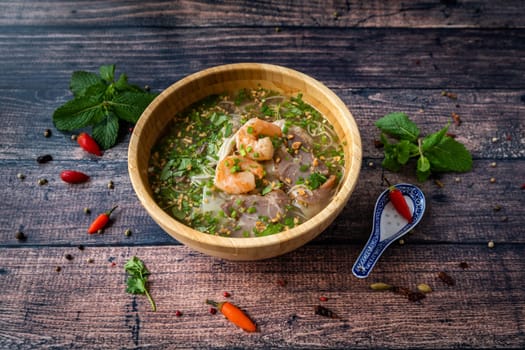 Vietnamese specialty : ravioli soup in a bowl and placed on a wooden table