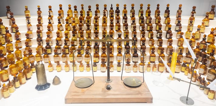 Grasse, France - August 2022: collection of ancient perfumes in laboratory with vintage balance