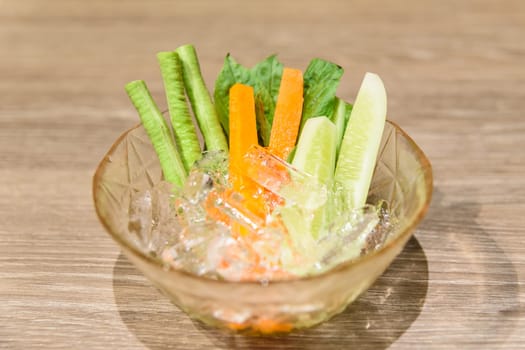 Fresh vegetables with ice in a bowl, selective focus