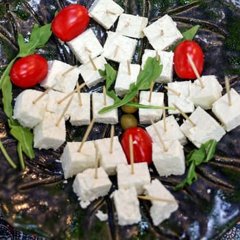 appetizers of white cheese and cherry tomatoes