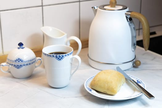 Breakfast on the kitchen table with fresh bread and coffee. High quality photo