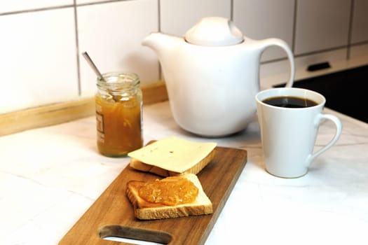 Breakfast served on the kitchen table with fresh toast bread and jam. High quality photo