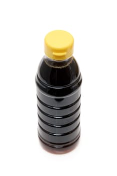 Plastic bottle of soy sauce on white background