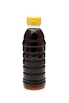 Plastic bottle of soy sauce on white background