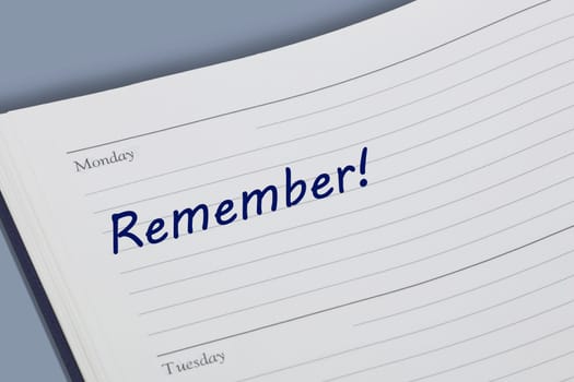 A Remember blue ink reminder note in a diary page