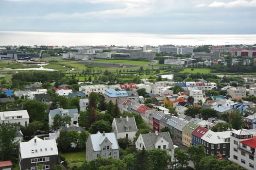 Aerial view of colorful buildings and lush greenery of Reykjavik, Iceland