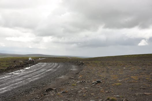 Scenic view of vehicles on gravel road in Iceland's inland