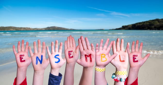 Children Hands Building Colorful English Word Ensemble. Summer Ocean, Sea And Beach As Background