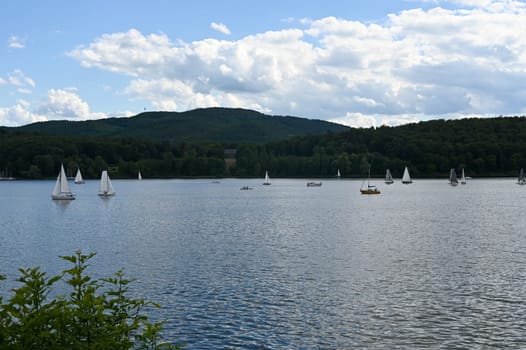 View of the lake Edersee with sailing boats, blue sky and clouds, in Hesse, Germany