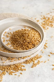 Plates of raw dry rye grain on white table close up, copy space. Healthy alternative low gluten seeds. Protein source for vegan and vegetarian diet.
