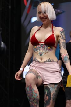 Krakow, Poland - June 11, 2022: Unidentified participant during the contest for the best tattoo at the 15th Tattoofest Convention in Cracow. One of the most prestigious tattoo festivals.