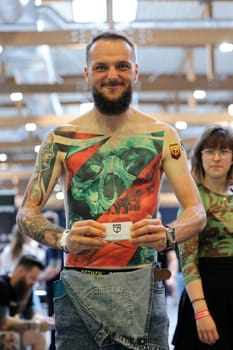 Krakow, Poland - June 11, 2022: Unidentified participant during the contest for the best tattoo at the 15th Tattoofest Convention in Cracow. One of the most prestigious tattoo festivals.