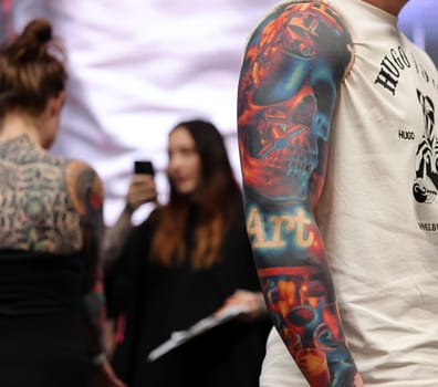 Krakow, Poland - June 12, 2022: Unidentified participant during the contest for the best tattoo at the 15th Tattoofest Convention in Cracow. One of the most prestigious tattoo festivals.