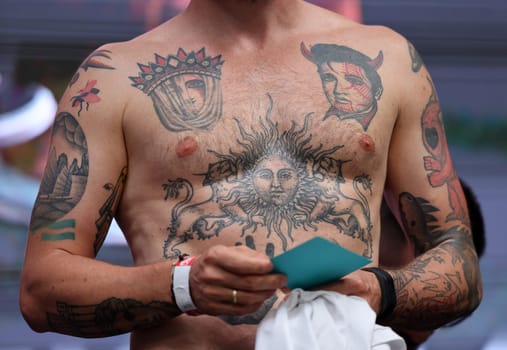 Krakow, Poland - June 11, 2022: Unidentified participant during the contest for the best tattoo at the 15th Tattoofest Convention in Cracow. One of the most prestigious tattoo festivals.