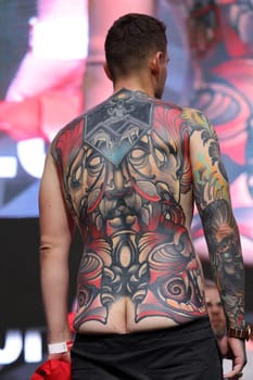 Krakow, Poland - June 11, 2022: Unidentified participant during the contest for the best tattoo at the 15th Tattoofest Convention in Cracow. One of the most prestigious tattoo festivals.