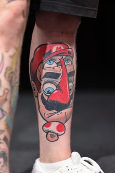 Krakow, Poland - June 11, 2022: Unidentified participant during the contest for the best tattoo at the 15th Tattoofest Convention in Cracow. One of the most prestigious tattoo festivals.
