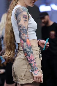 Krakow, Poland - June 12, 2022: Unidentified participant during the contest for the best tattoo at the 15th Tattoofest Convention in Cracow. One of the most prestigious tattoo festivals.