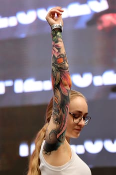 Krakow, Poland - June 12, 2022: Unidentified participant during the contest for the best tattoo at the 15th Tattoofest Convention in Cracow. One of the most prestigious tattoo festivals.