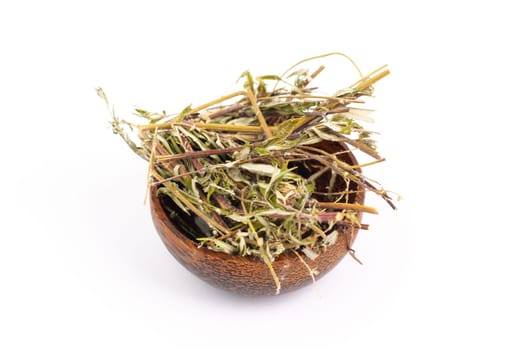 Mugwort or biboz leaves and twigs in a bowl isolated on a white background, dry herb for tea, alternative medicine