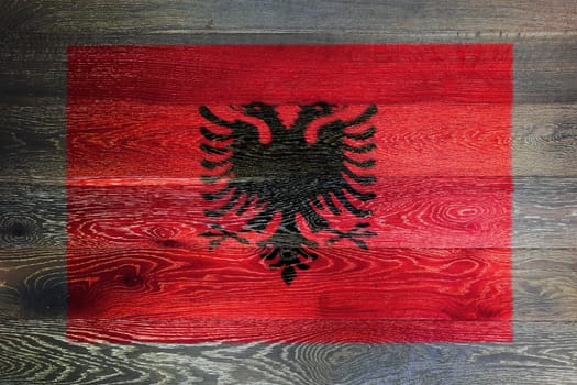 An Albania flag on rustic old wood surface background