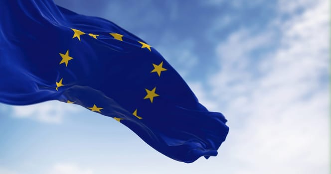 European Union flag waving in the wind on a clear day. Political and economic union of 27 European countries. 3d illustration render. Selective focus. Fluttering textile.